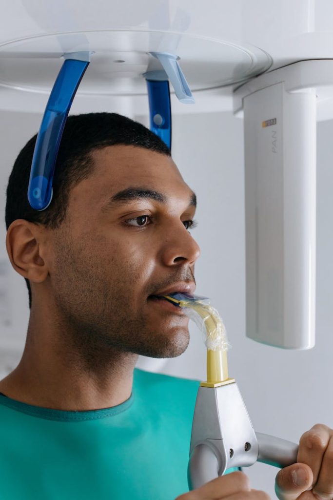 Close-up of a man receiving a dental x-ray scan in a clinic setting.