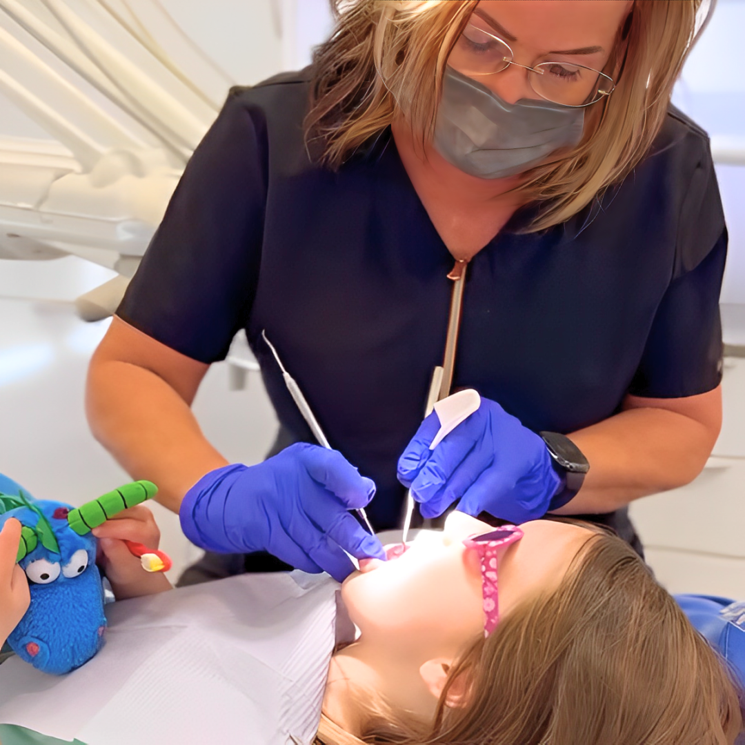 Detailed shot of a dentist applying veneer to a woman's teeth during a dental procedure.