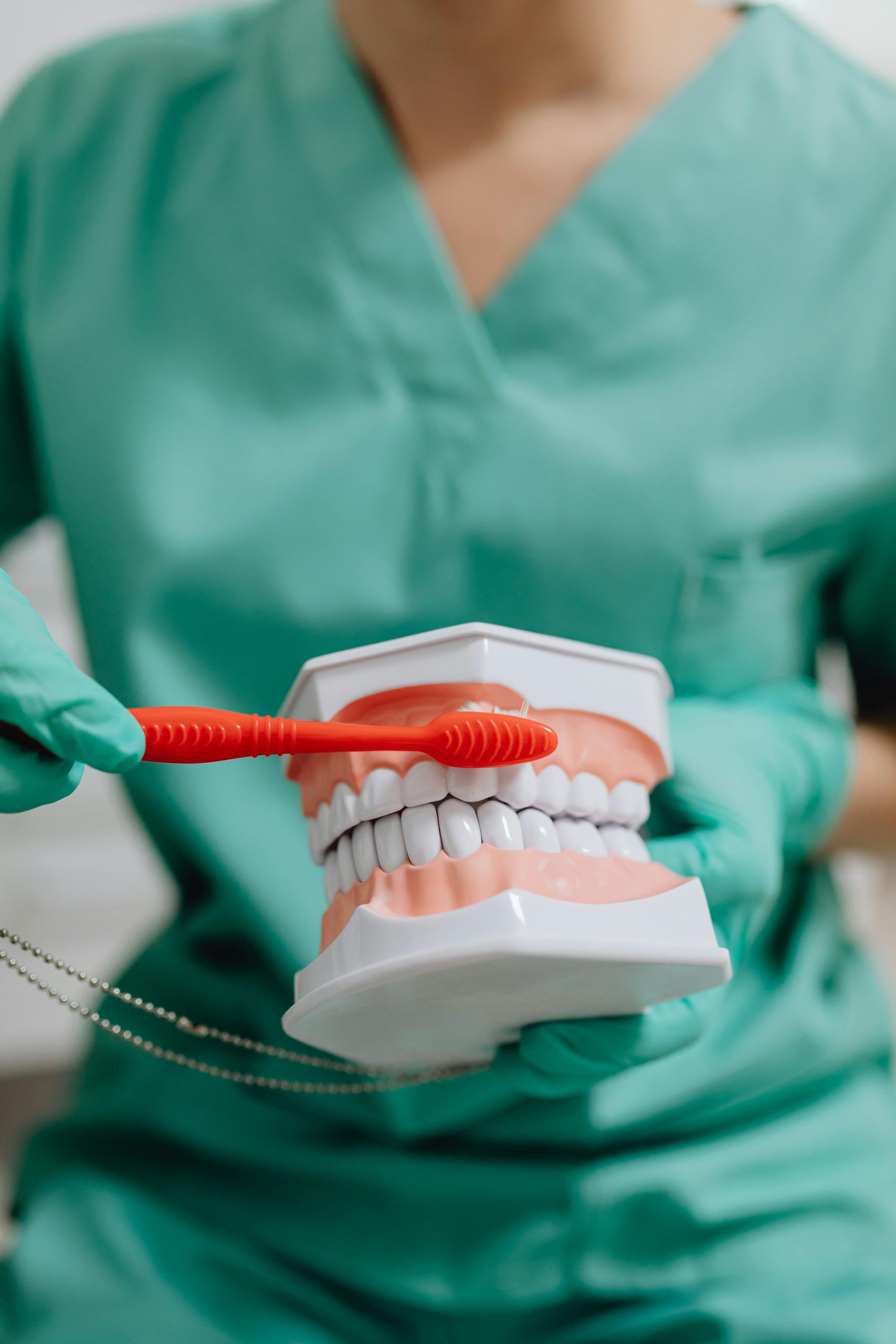 Detailed shot of a dentist applying veneer to a woman's teeth during a dental procedure.